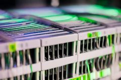 Closeup of server racks in a data center. AI generated via Canva, an online graphic design tool.